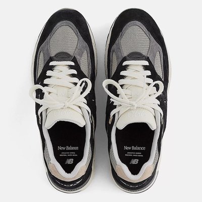 a pair of black and white sneakers on a white background