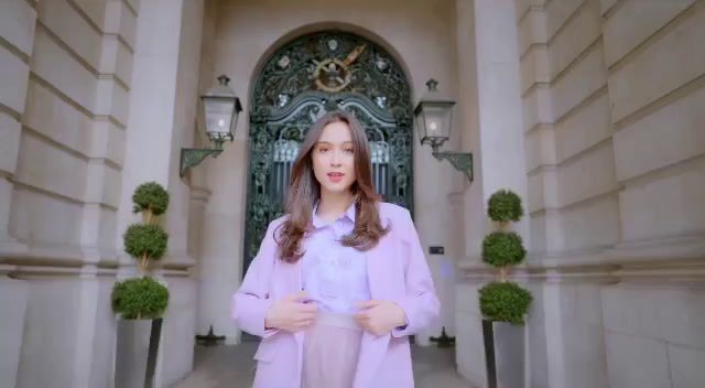 a woman standing in front of a building