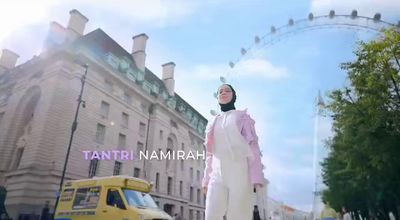 a woman in a hijab walking down a street