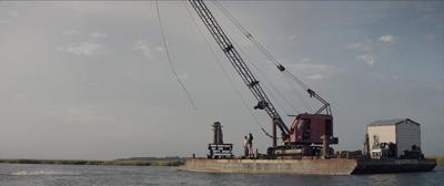 a large crane sitting on top of a body of water