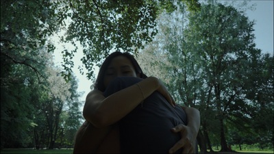 a woman holding a man in a park