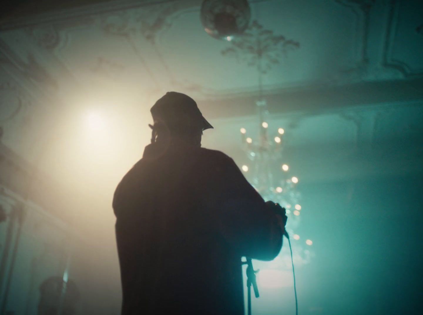 a silhouette of a man with a cane and a hat