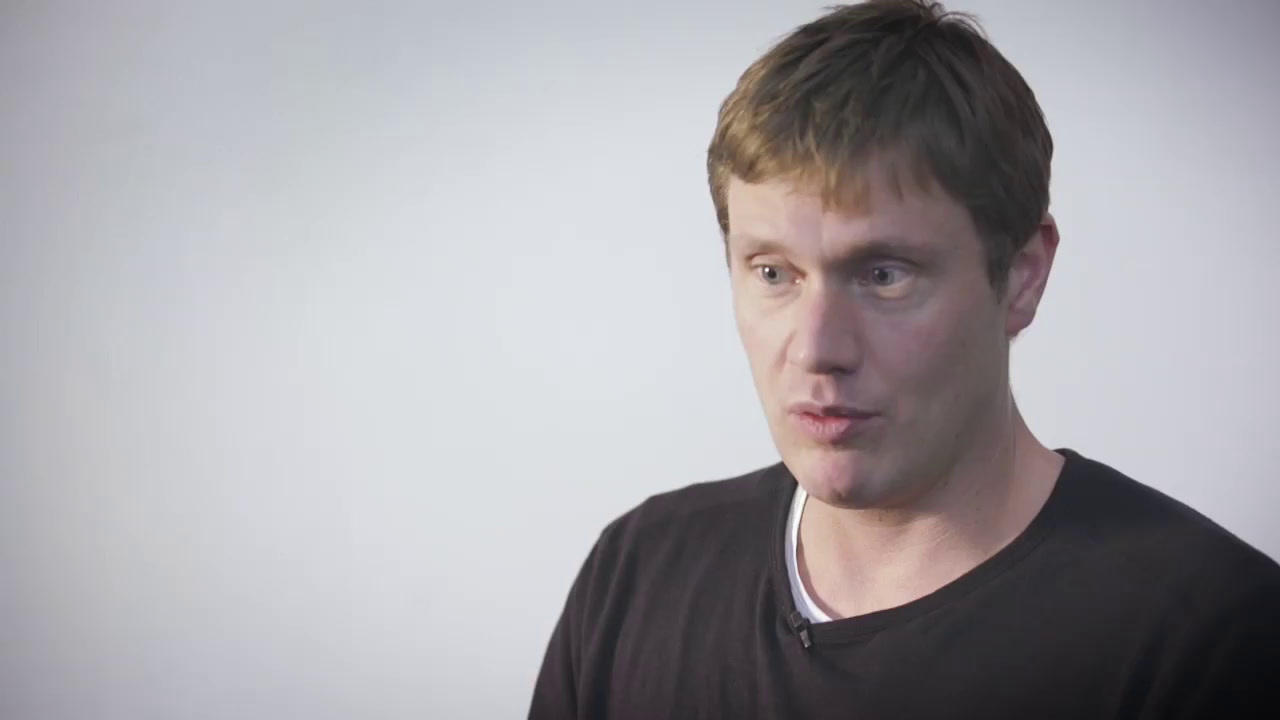 a man making a funny face while wearing a black shirt