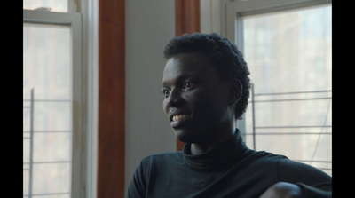 a man in a black shirt and a window