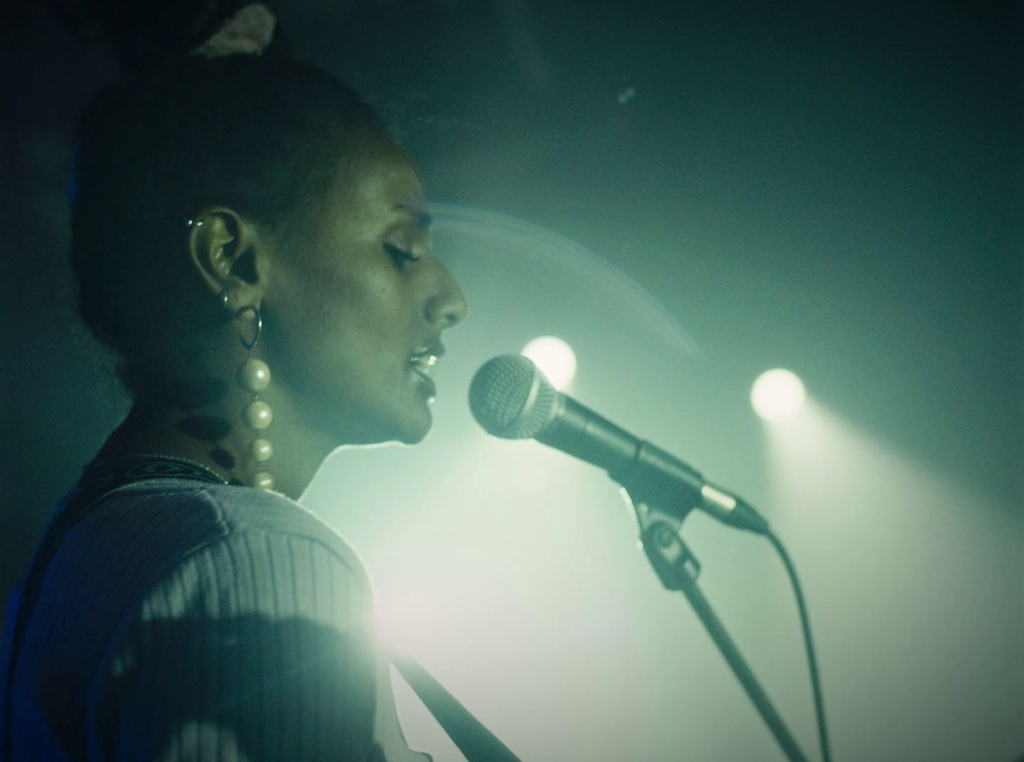 a woman standing in front of a microphone