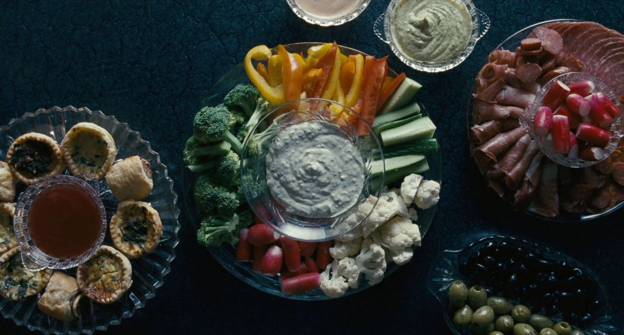 a table topped with plates of food and dips