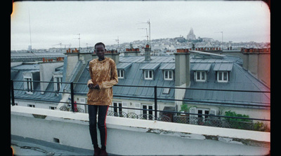 a woman standing on top of a roof