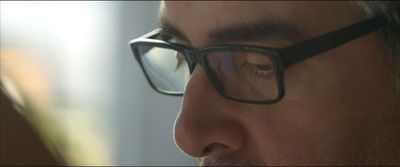 a close up of a person wearing glasses