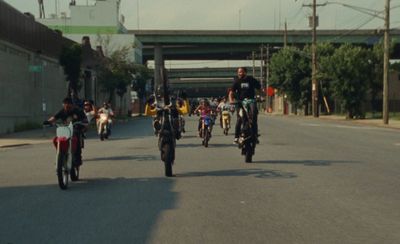 a group of people riding motorcycles down a street