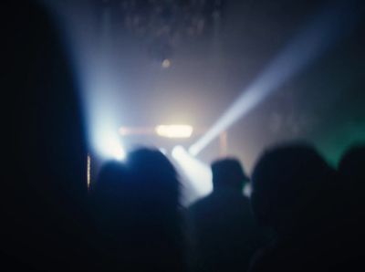 a group of people standing in front of a stage