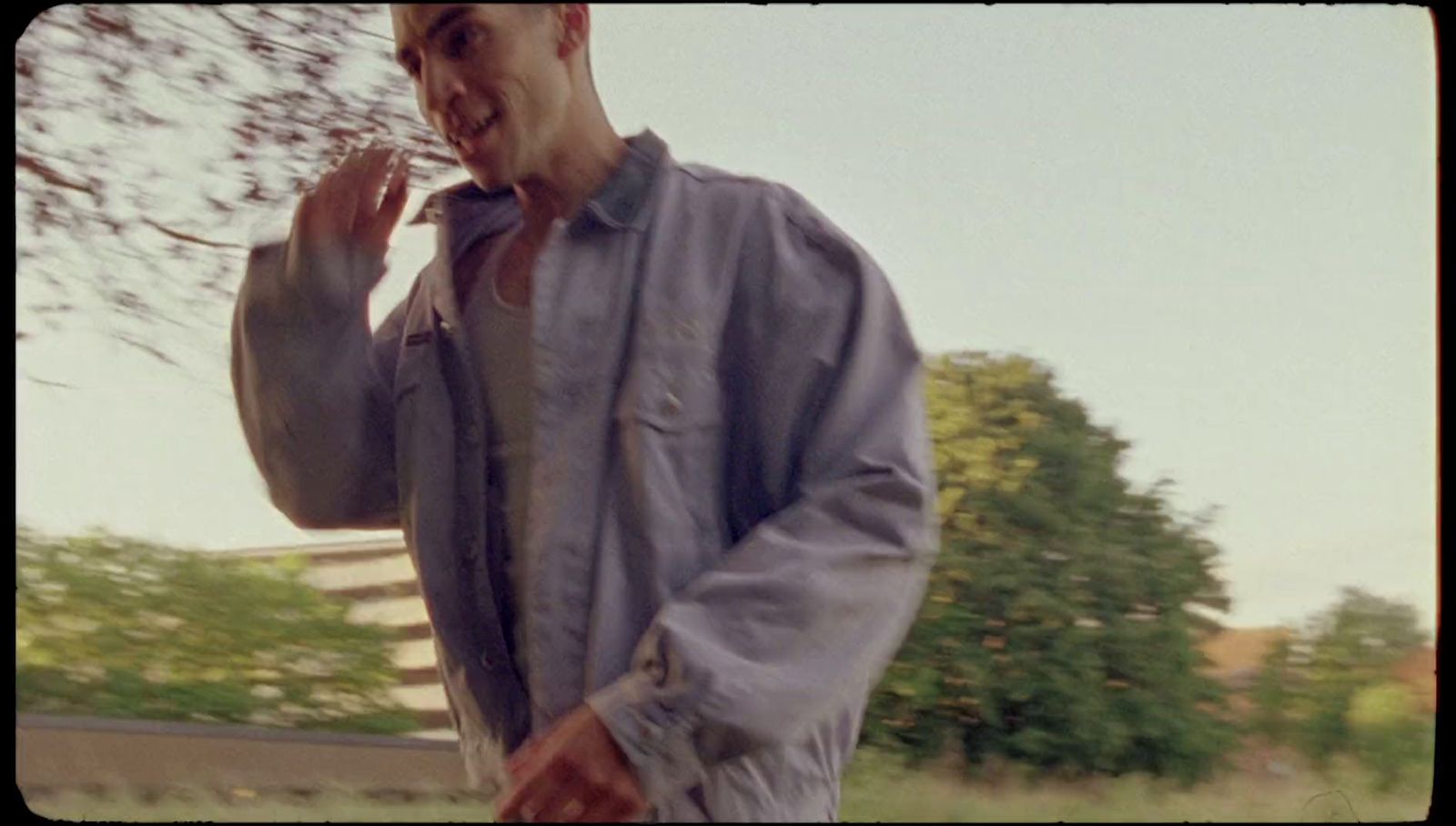 a man in a blue shirt is holding a cell phone