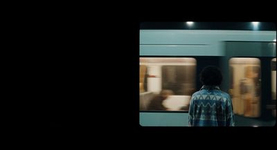 a man standing in front of a train at night