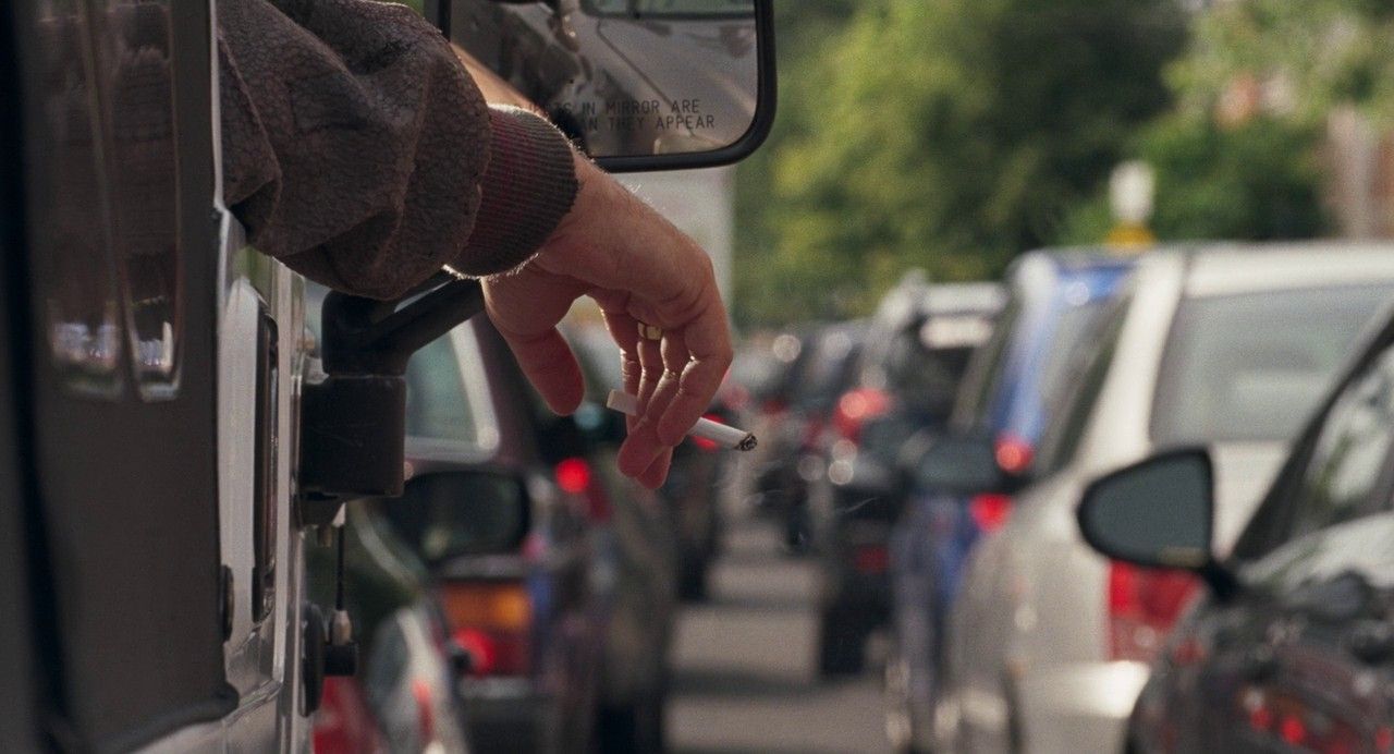 a person's hand is on the side of a bus