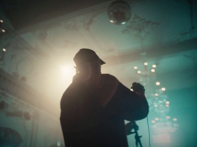 a man holding a microphone in a dark room