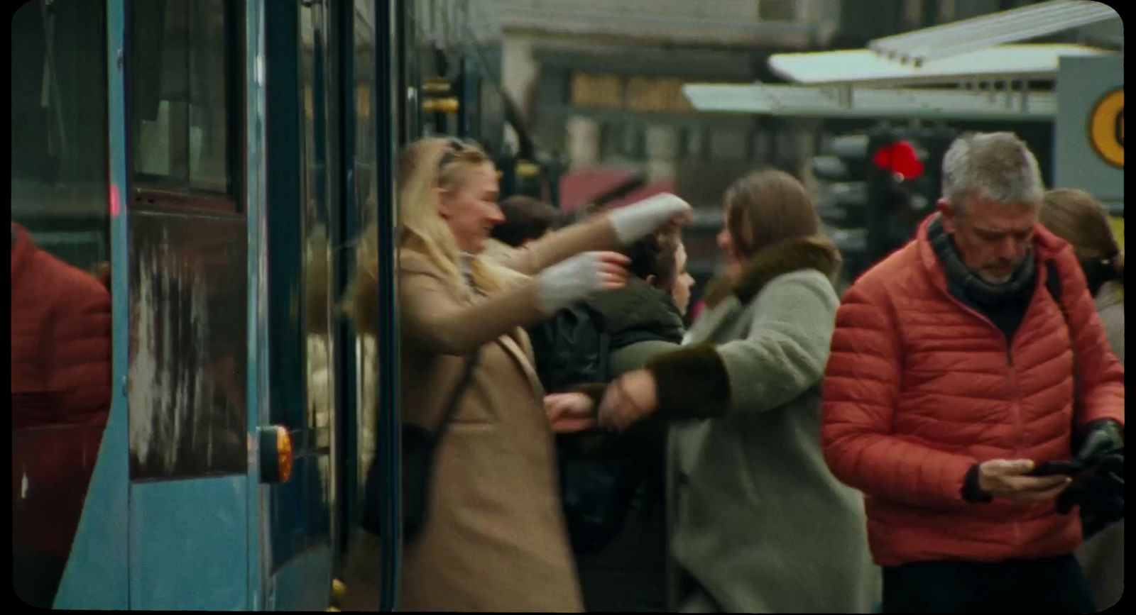 a group of people getting on a bus