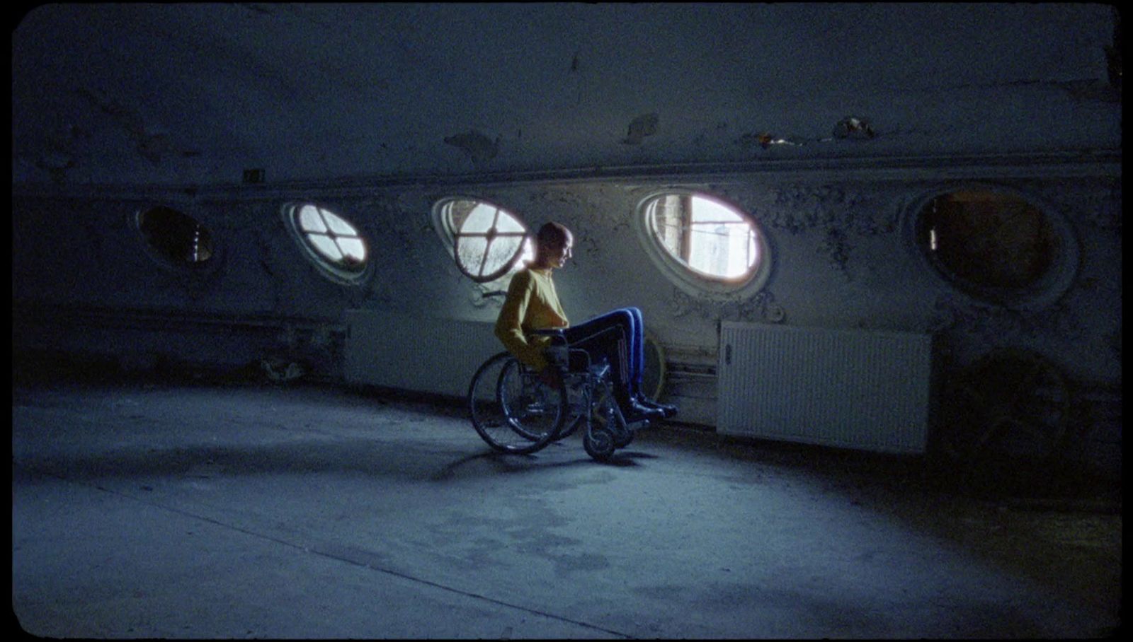 a person riding a bike in a room with round windows