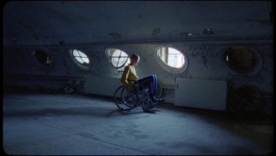 a person riding a bike in a room with round windows