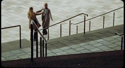 a man and a woman are walking down the stairs