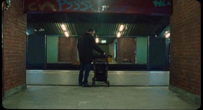 a man standing next to a luggage cart