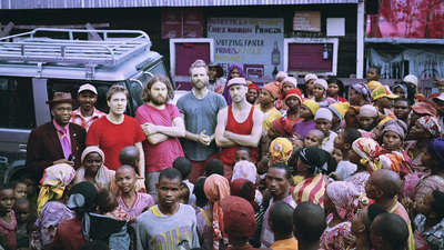 a group of people standing in front of a bus