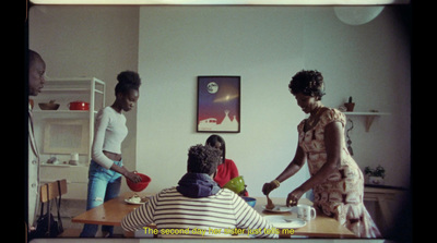 a group of people standing and sitting around a table