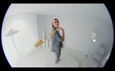 a woman standing in a room holding a large object