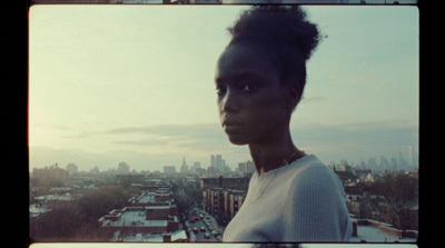 a woman standing in front of a city skyline