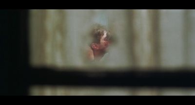 a blurry image of a man looking through a window