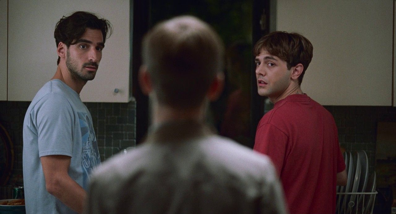 two men standing in a kitchen looking at each other