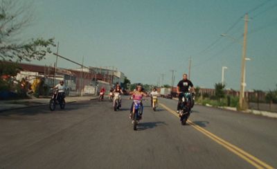 a group of people riding motorcycles down a street