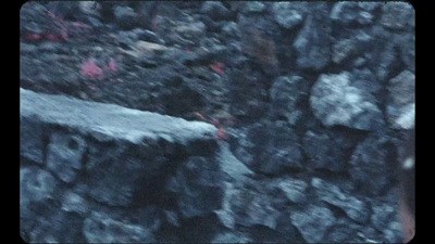 a black and white photo of rocks and a bench