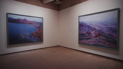 two paintings on a wall in a room