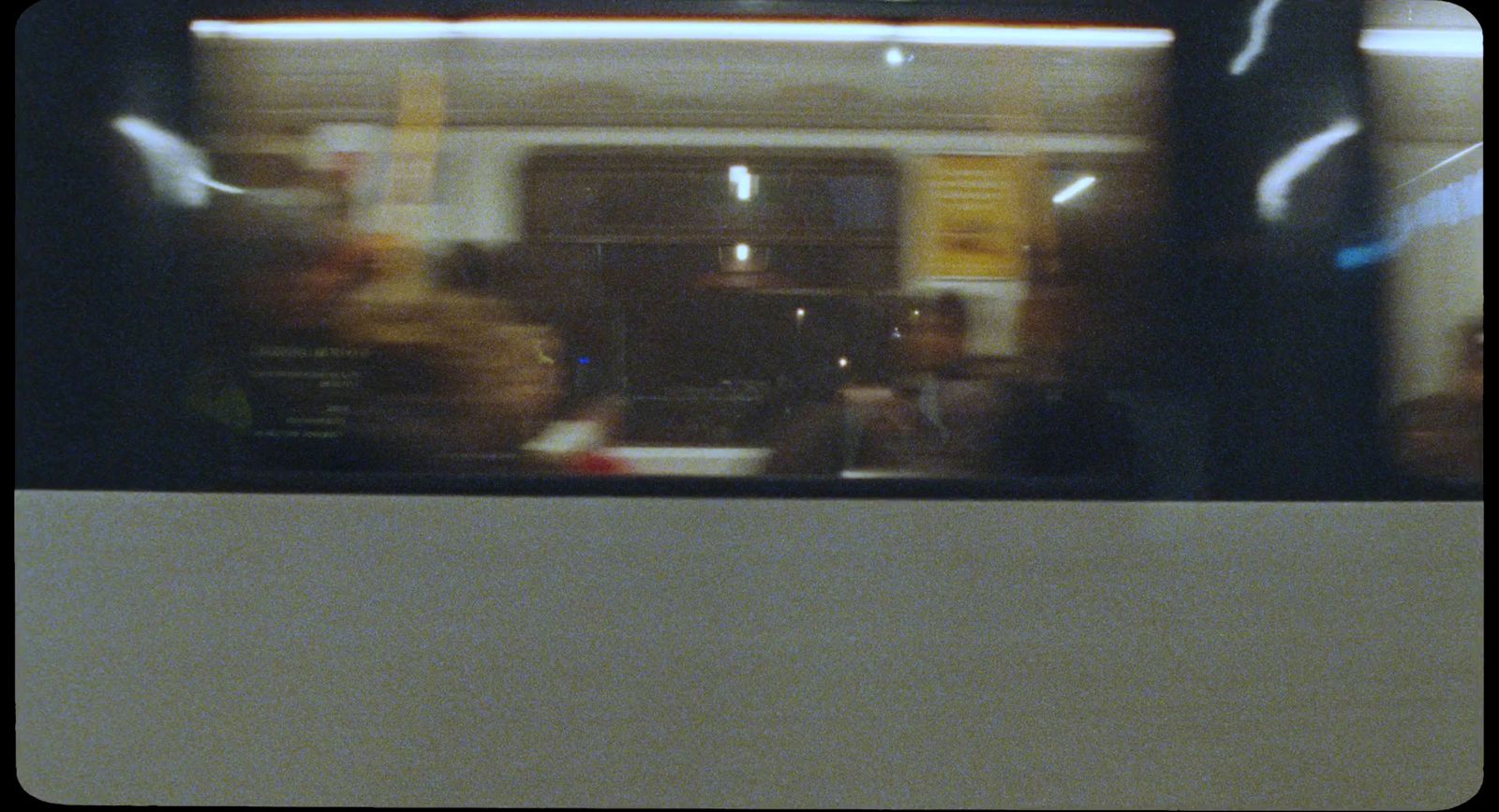 a blurry photo of people sitting on a train