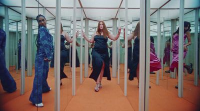 a group of women standing in a room with mirrors