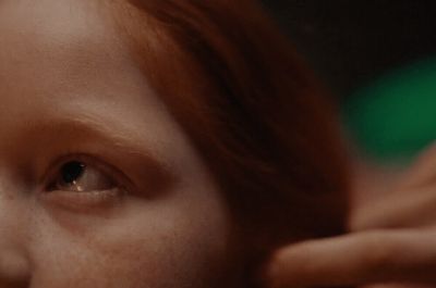 a close up of a woman's face with freckled hair