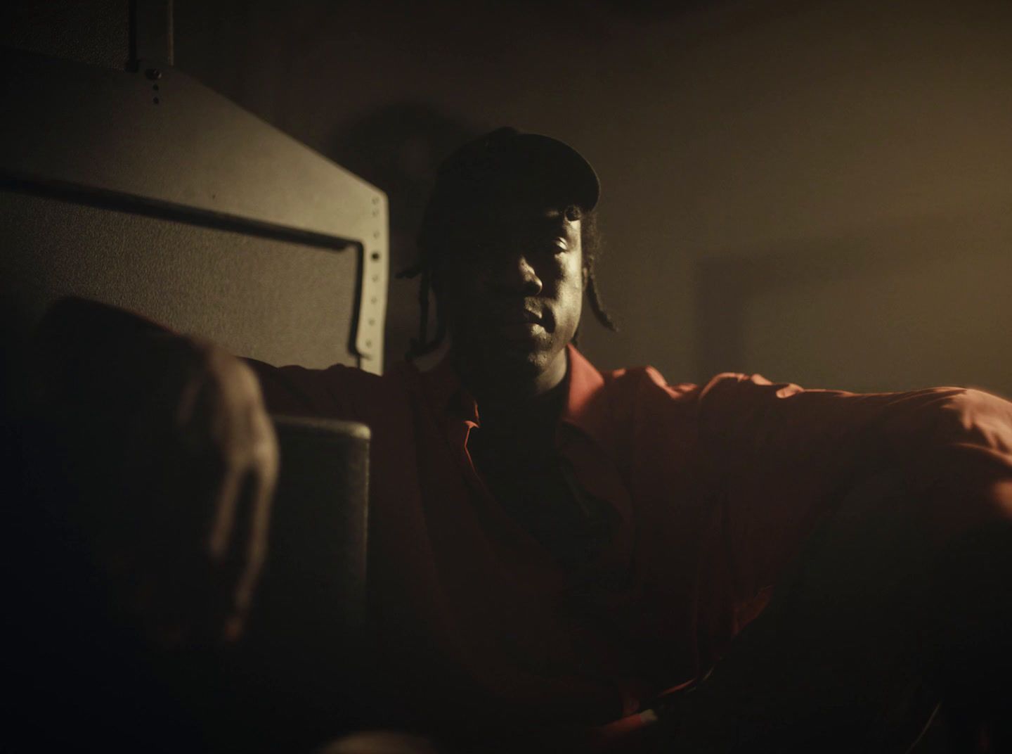 a man sitting in a dimly lit room