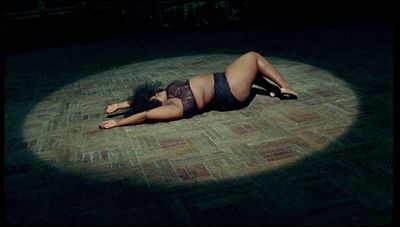 a woman in lingerie laying on the floor