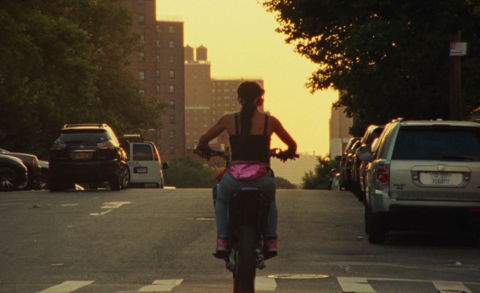 a woman riding a bike down a street