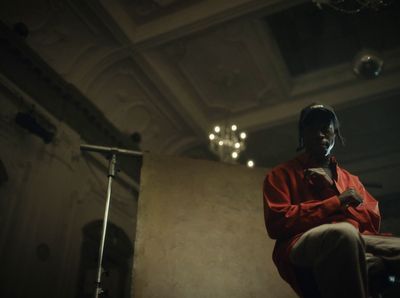 a man sitting in a chair in a dark room