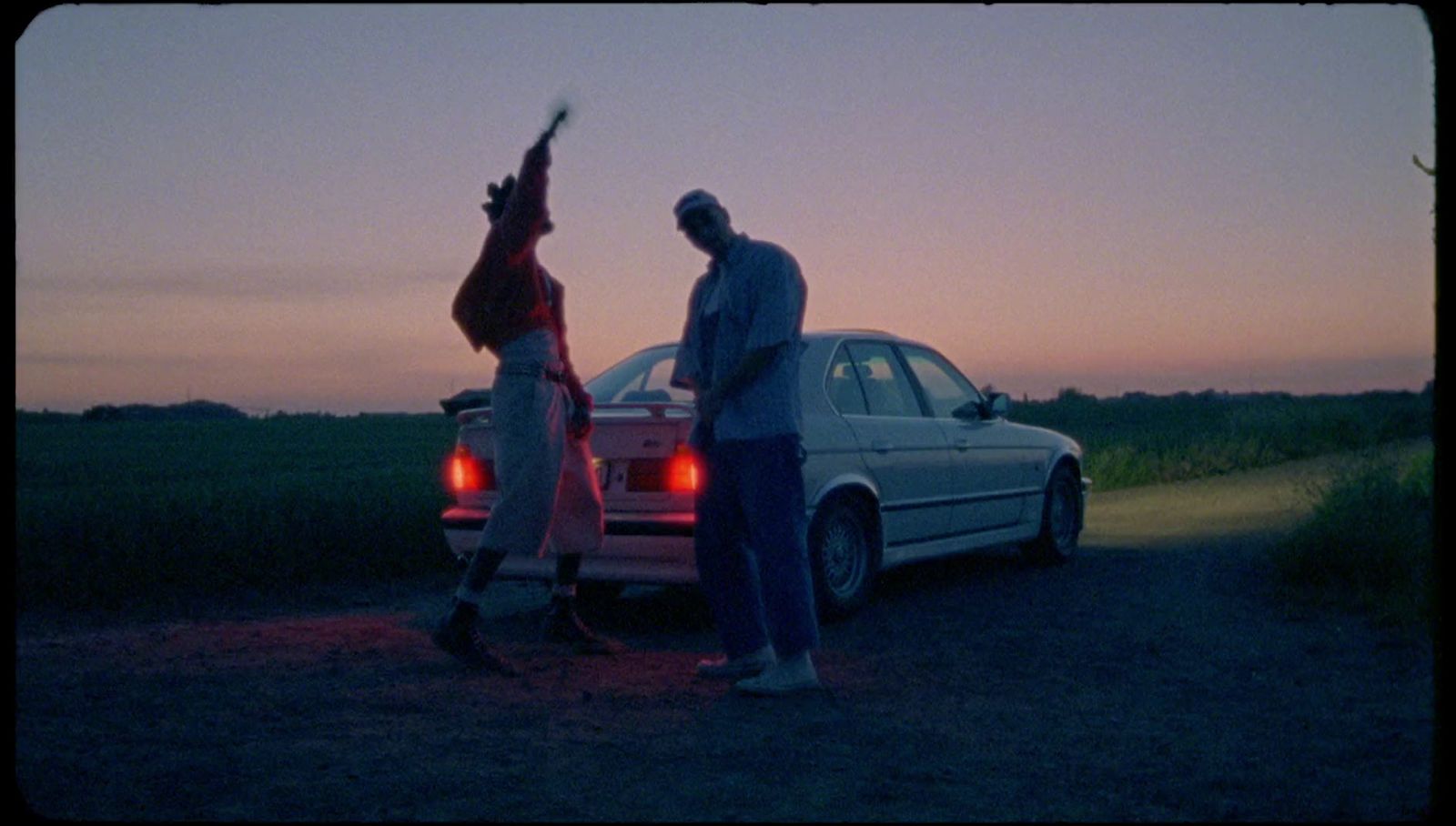 a couple of people standing next to a car