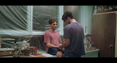 a couple of men standing in a kitchen next to each other