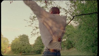 a man is throwing a frisbee in a park