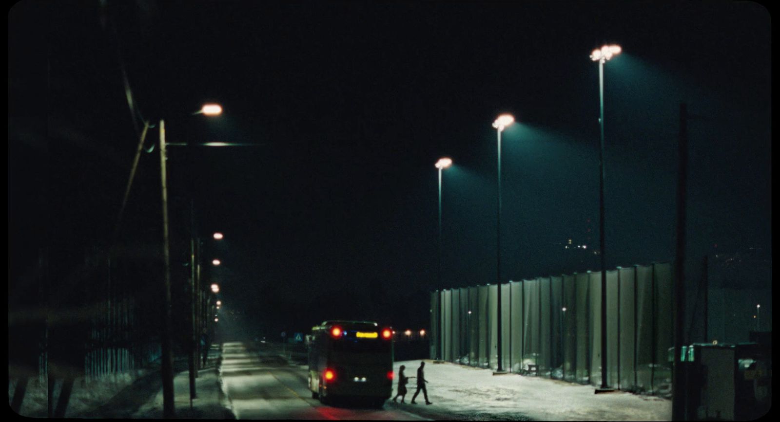 a car driving down a street at night