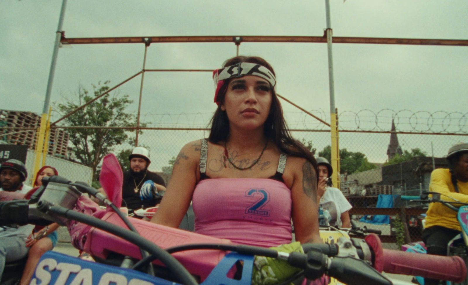 a woman sitting on top of a pink motorcycle