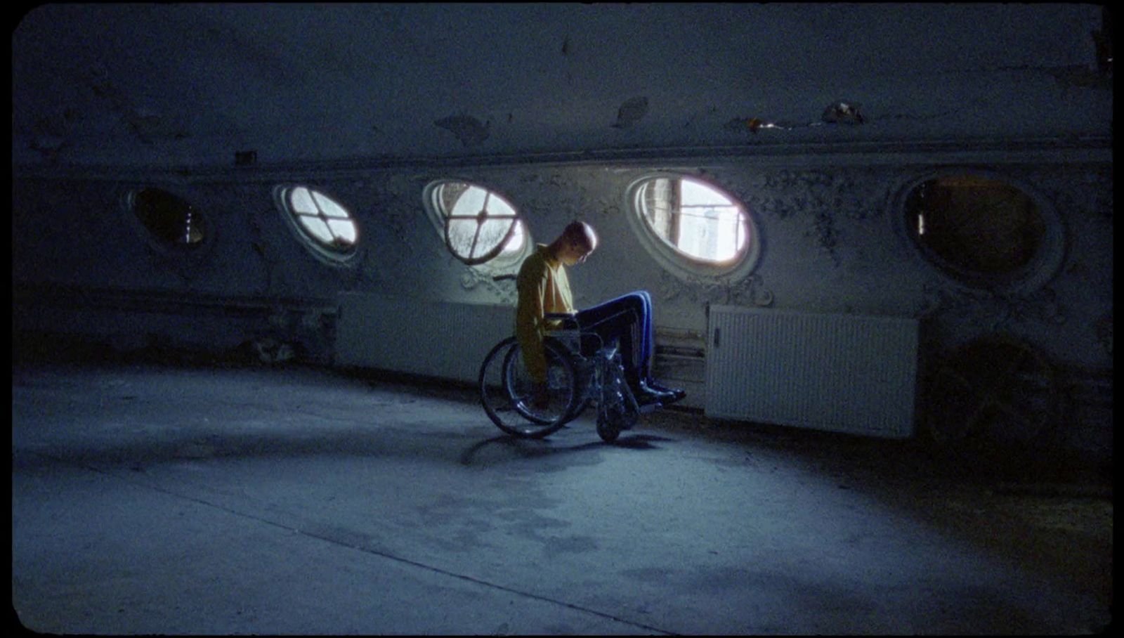 a man sitting on a wheel chair in a room