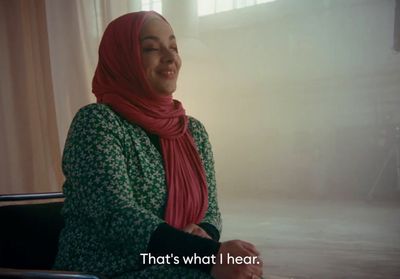 a woman wearing a hijab sitting in a chair