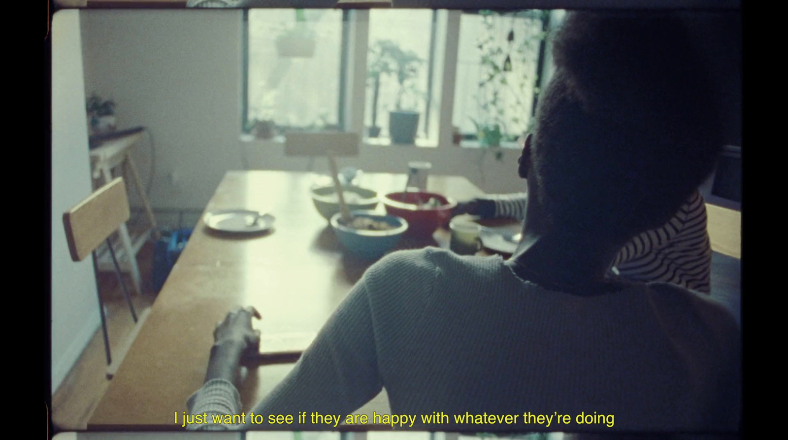 a person sitting at a table with a bowl of food