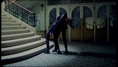 a woman standing in front of a set of stairs