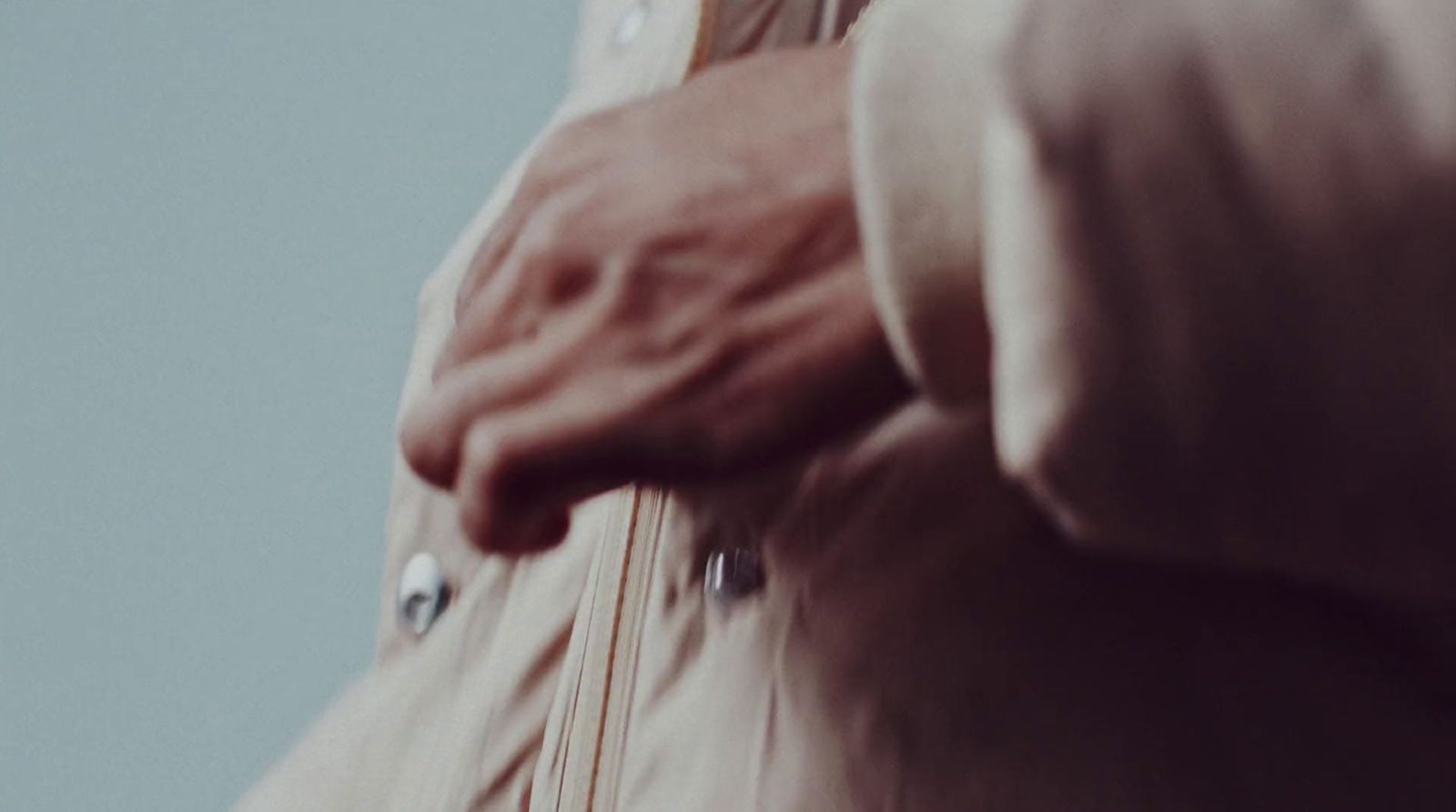 a close up of a person holding a piece of luggage