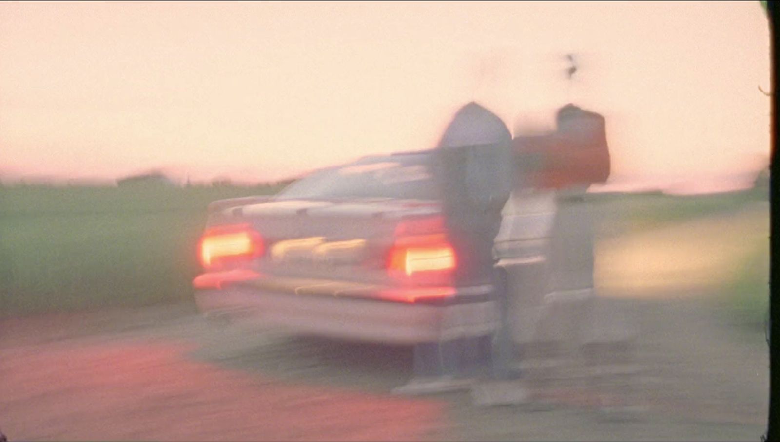 a blurry photo of a car parked next to a parking meter